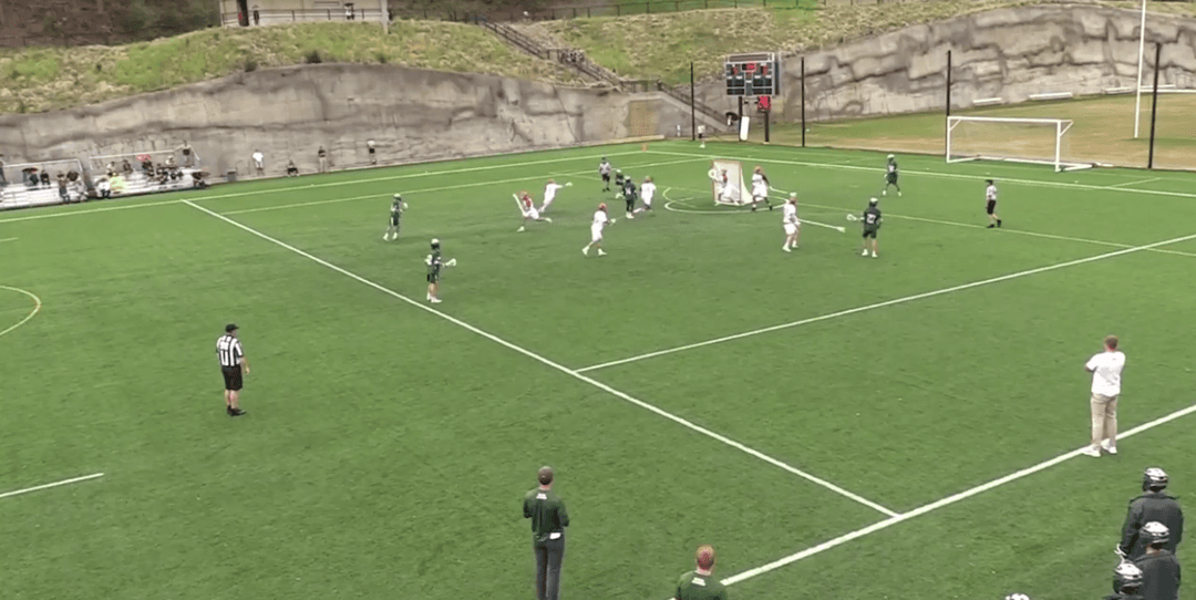 Two lacrosse players, one in white and one in black, jostle for position on the field.